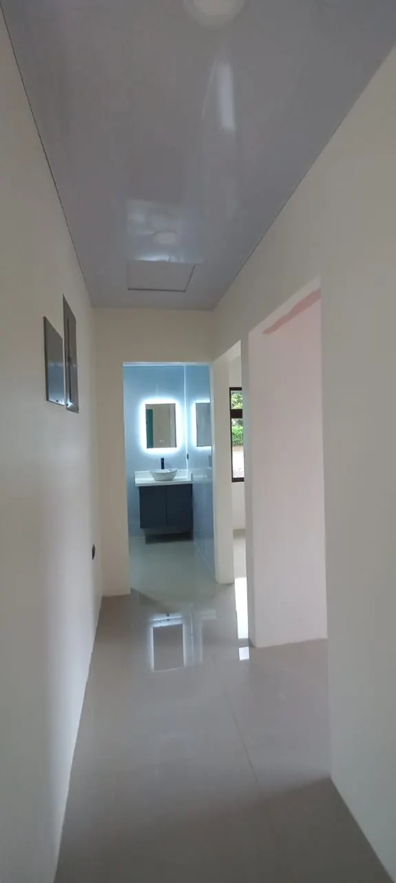 Pasillo interior con baño al final del pasillo.